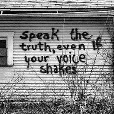 Spray painted words on the walls of a house: “Speak the truth, even if your voice shakes.”